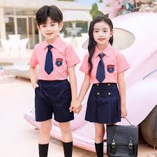 Pink school shirts paired with navy shorts and a skirt