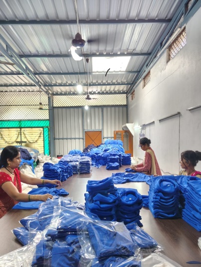 Garment production team working with blue fabrics in the garment profile